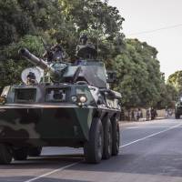 A convoy of Senegal soldiers heads toward the Gambia boarder with Senegal near Karang, Senegal, Thursday. Senegalese troops charged into neighboring Gambia late Thursday to support the country\'s newly inaugurated president, while longtime ruler Yahya Jammeh showed no sign of stepping down. | AP