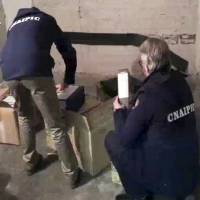 Officers of Italy’s National Anti Cybercrime Center and Critical Infrastructures Protection inspect boxes found after entering a garage during an operation code-named “Eye Pyramid” in this image taken from video. Italy arrests siblings for hacking into emails of ECB's Draghi, former Italy PM Renzi