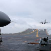 Chinese J-15 fighter jets launch Monday from the deck of the Liaoning aircraft carrier during military drills in the South China Sea. The aircraft carrier is one of the latest steps in the years-long buildup of China\'s military, as Beijing seeks greater global power to match its economic might and asserts itself more aggressively in its own backyard. | AFP-JIJI