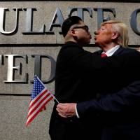American Dennis Alan impersonates U.S. President Donald Trump with \"Howard,\" an Australian-Chinese man who gave his first name while impersonating North Korean leader Kim Jong Un outside the U.S. Consulate in Hong Kong on Wednesday. | REUTERS