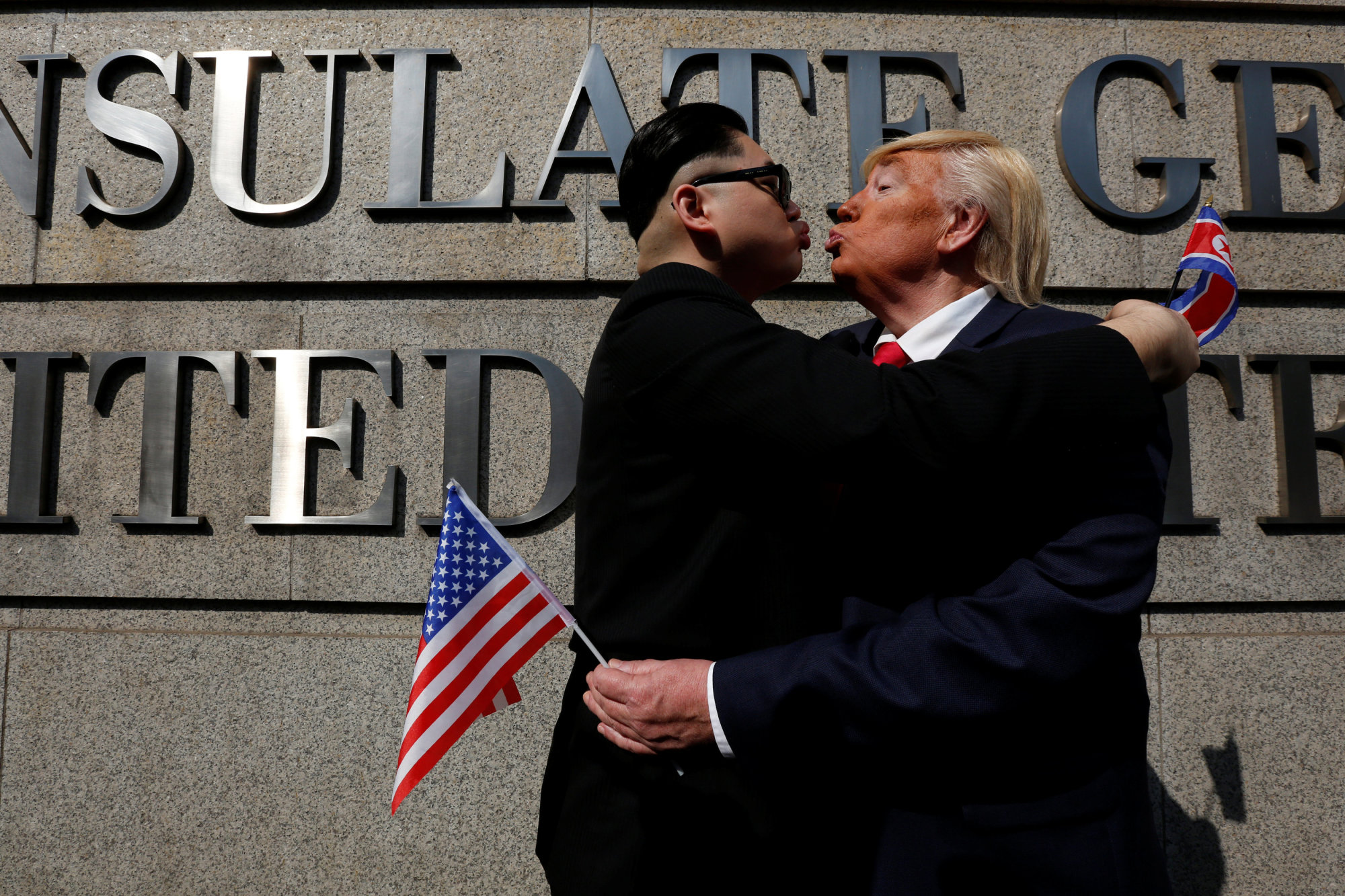 American Dennis Alan impersonates U.S. President Donald Trump with 'Howard,' an Australian-Chinese man who gave his first name while impersonating North Korean leader Kim Jong Un outside the U.S. Consulate in Hong Kong on Wednesday. | REUTERS