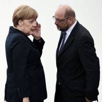 German Chancellor Angela Merkel speaks with the European Parliament President Martin Schulz at the Douaumont Ossuary in northeastern France during a ceremony marking the centenary of the World War I Battle of Verdun last May. | AFP-JIJI