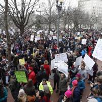Protesters carry signs and chant in Lafayette Park near the White House, during a demonstration to denounce President Donald Trump\'s executive order that bars citizens of seven predominantly Muslim-majority countries from entering the U.S., on Sunday in Washington. | AP
