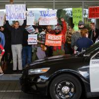Demonstrators shout slogans during anti-Donald Trump immigration ban protests outside Terminal 4 at San Francisco International Airport Saturday. | REUTERS