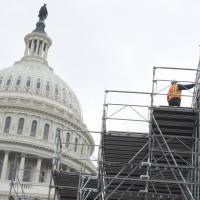 Workers build portions of the inaugural platform for the inauguration of President-elect Donald Trump at the U.S. Capitol in Washington, DC, Dec. 8. Trump ramped up preparations for his inauguration on Thursday, working with aides on an historic address that will be seen as a cornerstone of his administration. | AFP-JIJI