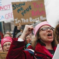 Protesters cheer at the Women\'s March on Washington during the first full day of Donald Trump\'s presidency on Saturday. | AP