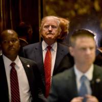 U.S. President-elect Donald Trump arrives from the elevator at Trump Tower in New York on Monday. | AFP-JIJI