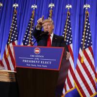 U.S. President-elect Donald Trump calls on a reporter during a news conference &#8212; his first as president-elect &#8212; in the lobby of Trump Tower in New York on Wednesday. | AP