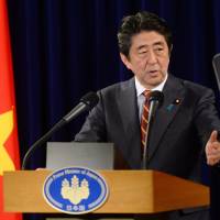Prime Minister Shinzo Abe holds a news conference in Hanoi on Monday. | AP
