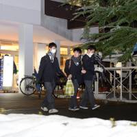 High school students who took the two-day unified college extrance examinations over the weekend leave their venue in Hiroshima Sunday. | KYODO
