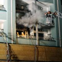 Firefighters battle a blaze that started in a unit of a 26-story condominium high-rise in Tokyo\'s Toshima Ward on Tuesday. | KYODO