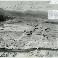 This aerial photo shows the A-bombed city of Hiroshima in January 1946. It carries signatures of three crew members of the Enola Gay. | HIROSHIMA PEACE MEMORIAL MUSEUM / VIA KYODO
