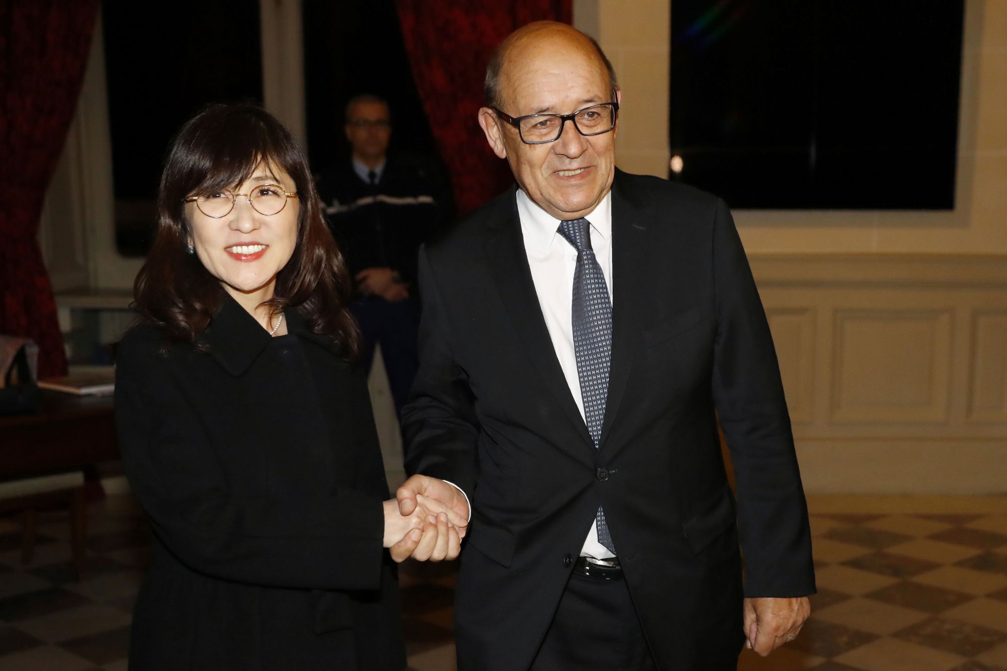 Defense Minister Tomomi Inada is welcomed by French Defense Minister Jean-Yves Le Drian ahead of talks in Paris on Friday. | AFP-JIJI