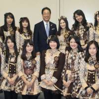 Toshiki Kudo, mayor of Hakodate, Hokkaido, poses with members of the JKT48 pop group Monday at City Hall. | KYODO