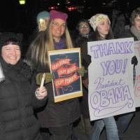 Participants of the march held Friday in Tokyo walk with signs expressing gratitude to outgoing U.S. President Barack Obama. | YOSHIAKI MIURA