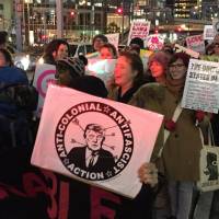 People join an Osaka rally to protest the new U.S. president Donald Trump ahead of the inauguration ceremony. | ERIC JOHNSTON