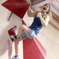 Miho Nonaka shows her sports climbing skills at a bouldering event in Tokyo in December. | KAZ NAGATSUKA