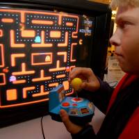 Jake Gautney of Chappaqua, New York, plays a home version of \"Ms. Pac-Man\" at the Toy Industry Association holiday preview in New York in October 2004. Masaya Nakamura, considered \"the father of Pac-Man\" as the founder of the video game company behind the hit game, died Jan. 22. | AP
