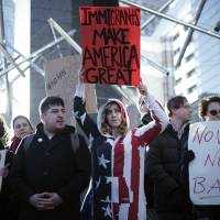 Americans and other expats gather to protest against President Donald Trump\'s recent travel ban, outside the U.S. Embassy in Tokyo on Tuesday. | AP