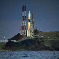 An HIIA rocket carrying the Kirameki-2 defense communication satellite stands on a launch pad at Tanegashima Space Center in Kagoshima Prefecture on Tuesday. | KYODO