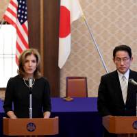 U.S. Ambassador Caroline Kennedy delivers a speech beside Foreign Minister Fumio Kishida prior to a signing ceremony at the Iikura guesthouse in Tokyo on Monday. | AFP-JIJI