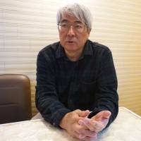 Yukihisa Fujimoto, filmmaker and co-producer of documentaries on protests over the U.S. military presence in Okinawa, is interviewed by The Japan Times in Tokyo last month. | MAGDALENA OSUMI