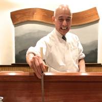 Warm welcome: Owner-chef Tsuneo Yokota serves his anago (sea eel) with a smile. | ROBBIE SWINNERTON