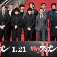 Paint it red: Director Sion Sono (back row, left) and producer Mataichiro Yamamoto (back row, right) join the cast of the film \"Shinjuku Swan II\" for the premiere at Roppongi Hills Toho Cinemas on Jan. 8. | YOSHIAKI MIURA