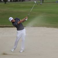 Justin Thomas hits out of a bunker on the 16th fairway during the final round of the Sony Open on Sunday in Honolulu. Thomas won with the lowest 72-hole score in PGA Tour history. Thomas sets 72-hole record in Sony victory