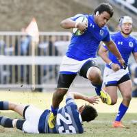 Tokai University\'s Tevita Tatafu attacks the Doshisha University defense during their collegiate rugby championship semifinal on Monday. | KYODO