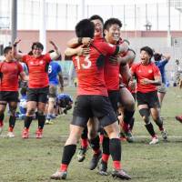Teikyo University players celebrate after beating Tokai University in the final of the national collegiate rugby championship at Prince Chichibu Memorial Rugby Ground on Monday. | KYODO