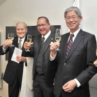 Panama\'s Ambassador Ritter Diaz (second from left) and his wife Ayana Hatada Diaz (right) share a toast with Father Arturo Martin (left) and the Director General of the Foreign Ministry\'s Latin American and Caribbean Affairs Bureau Yasushi Takase during a reception to celebrate the relocation of the Embassy of the Republic of Panama to the  Samon Building in Higashi-Azabu, Minato Ward in Tokyo on Jan. 10. | YOSHIAKI MIURA