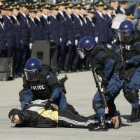A member of the Metropolitan Police Department subdues a man during its traditional new year counterterrorism drill in Koto Ward, Tokyo, on Friday as Japan hones security measures ahead of the 2020 Tokyo Olympic Games. | KYODO