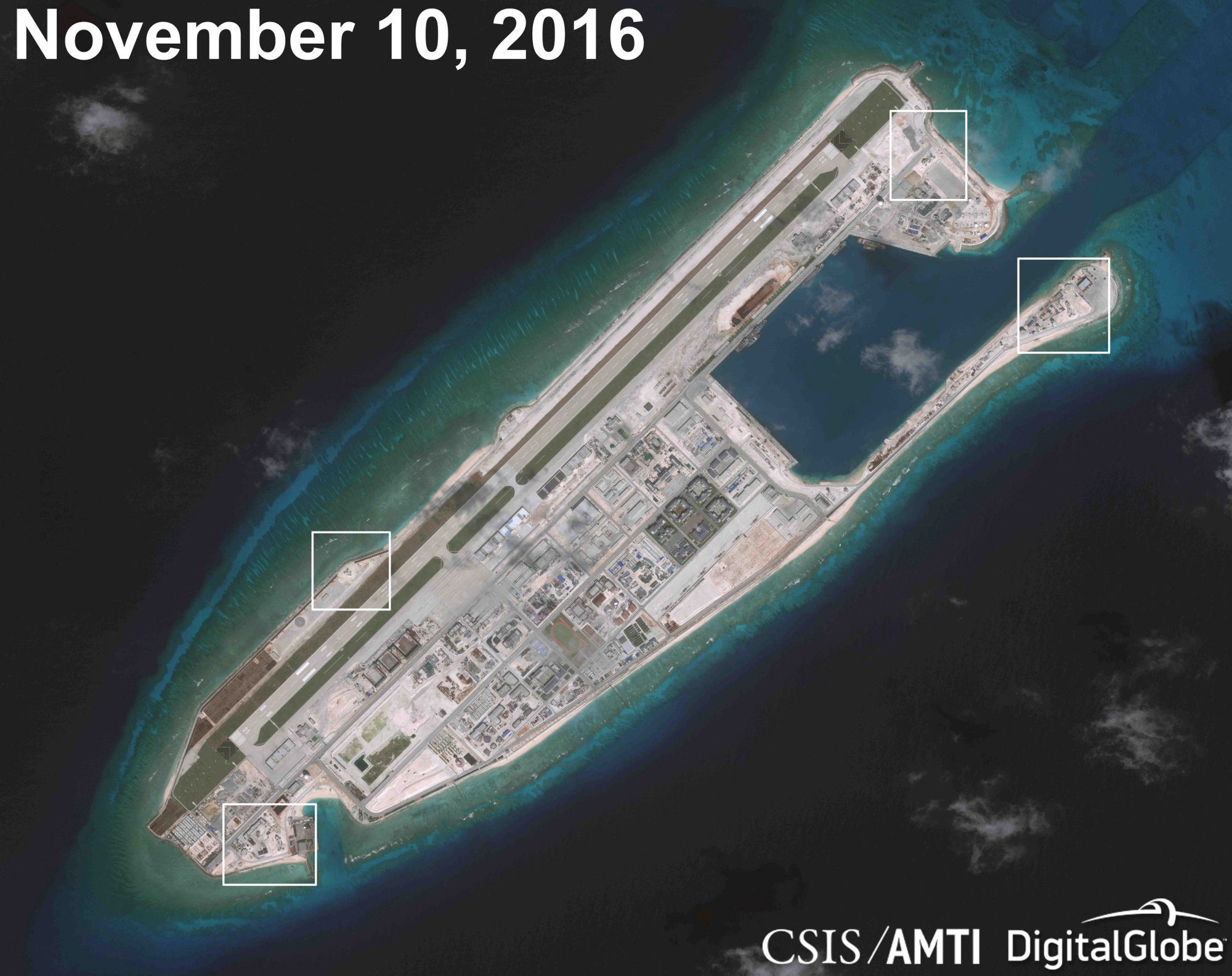 A satellite image shows what appears to be anti-aircraft guns and what are likely to be close-in weapons systems on the artificial island at Fiery Cross Reef in the South China Sea in this image released Dec. 13. | CSIS ASIA MARITIME TRANSPARENCY INITIATIVE / DIGITALGLOBE / VIA REUTERS