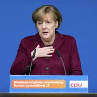 German Chancellor Angela Merkel delivers a speech at a local meeting of her Christian Democrats, CDU, in Grimmen, northern Germany, Saturday. Merkel said there\'s no solution yet to the problem of how to fairly share the burden of migration among European Union member states. | STEFAN SAUER / DPA VIA AP