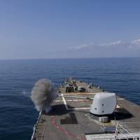 This U.S. Navy photo obtained Thursday shows the Arleigh Burke-class guided-missile destroyer USS Cole (DDG 67) as it fires a Mark 45 5-inch gun during a live-fire exercise on Feb. 2. The Cole is deployed in the 5th Fleet area of operations in support of maritime security operations and theater security cooperation efforts. | NAVY OFFICE OF INFORMATION / HANDOUT / AFP-JIJI
