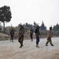 Free Syrian Army fighters patrol outside the northern town of al-Bab on Feb. 4. | REUTERS