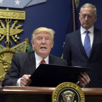 President Donald Trump (left), with Defense Secretary James Mattis, explains the executive action on extreme vetting that he is about to sign at the Pentagon in Washington Jan. 27. | AP