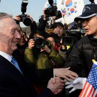 U.S. Defense Secretary James Mattis shakes hands with pro-U.S. activists during his visit to the national cemetery in Seoul, South Korea, on Friday. | REUTERS