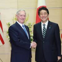 U.S. Defense Secretary James Mattis and Prime Minister Shinzo Abe shake hands at the Prime Minister\'s Office on Friday. | REUTERS