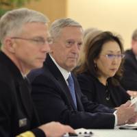 U.S. Defense Secretary James Mattis (center) chats with Foreign Minister Fumio Kishida at the Foreign Ministry on Friday. | AP