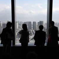 Visitors view Tokyo Bay, including the Harumi and Odaiba waterfront districts, from an observatory about 200 meters above street level Feb. 20 in Minato Ward, Tokyo. | SATOKO KAWASAKI