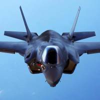 A U.S.Marine Corps F-35B joint strike fighter jet conducts maneuvers during aerial refueling training over the Atlantic Ocean in this undated picture released in 2015. Japan wins cost cuts from U.S. on F-35 fighter jet package