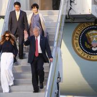President Donald Trump and first lady Melania Trump accompany Prime Minister Shinzo Abe and his wife, Akie, as they arrive at Palm Beach International Airport in West Palm Beach, Florida, on Friday. | AP