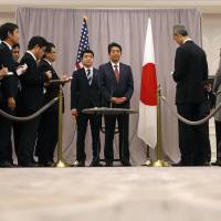 Prime Minister Shinzo Abe talks to the media after his first meeting with then U.S. President-elect Donald Trump in New York on Nov. 17, 2016. Business leaders critical of Abe's overtures to Trump