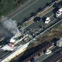 Burning vehicles are seen on the Kyushu Expressway in Kumamoto Prefecture after a pileup on Tuesday. | KYODO
