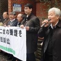 Second-generation hibakusha and their supporters gather outside the Nagasaki District Court on Monday before filing their case to seek compensation over health issues as a result of the 1945 U.S. atomic bombing of the city. | KYODO