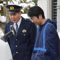 Yasutaka Tsurumoto leaves a police station in Yamagata on Tuesday to be handed to prosecutors on rape charges. | KYODO
