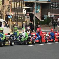 People drive go-karts in Tokyo from Tokyo-based rental service MariCar on Friday. | MAGDALENA OSUMI