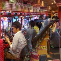 Customers play pachinko in Tokyo. Such players spent &#165;23.3 trillion in 2015. | BLOOMBERG